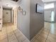 A hallway with gray walls, tiled flooring and white doors and trim at 8439 Adele Rd, Lakeland, FL 33810