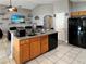Open concept space showcasing the kitchen with an island and wood cabinets, adjacent to the living area at 8439 Adele Rd, Lakeland, FL 33810