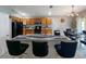 Modern kitchen features a breakfast bar, wood cabinets, black appliances, and an adjacent dining area at 8439 Adele Rd, Lakeland, FL 33810