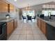 Kitchen with wood cabinets, black appliances, and an adjacent dining area with backyard views at 8439 Adele Rd, Lakeland, FL 33810