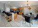 Well-lit kitchen with wood cabinets, black appliances, bar seating, and an adjacent dining area at 8439 Adele Rd, Lakeland, FL 33810