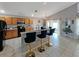 Bright open kitchen with wood cabinets, black appliances, a breakfast bar and adjacent dining area at 8439 Adele Rd, Lakeland, FL 33810