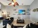 This living room features sofas, a television, shelving, and a ceiling fan at 8439 Adele Rd, Lakeland, FL 33810