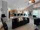 Spacious living room boasts tile flooring, high ceilings, and modern black furniture for a stylish space at 8439 Adele Rd, Lakeland, FL 33810