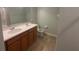Bathroom featuring a double vanity with wood cabinets and tile flooring at 878 Benjamin Trl, Davenport, FL 33837