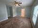 Bedroom featuring neutral carpet, a ceiling fan, and natural light from the window at 878 Benjamin Trl, Davenport, FL 33837