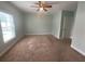 Bedroom featuring neutral carpet, a window, and a white door at 878 Benjamin Trl, Davenport, FL 33837