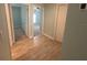 Bright hallway featuring wood-look tile flooring and doorways leading to other rooms at 878 Benjamin Trl, Davenport, FL 33837