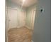 Hallway featuring wood-look tile flooring and white doors at 878 Benjamin Trl, Davenport, FL 33837