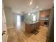 Open kitchen featuring a large island, stainless steel appliances, and seamless access to the living area at 878 Benjamin Trl, Davenport, FL 33837