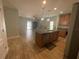 Open kitchen featuring a large island, stainless steel appliances, and seamless access to the living area at 878 Benjamin Trl, Davenport, FL 33837