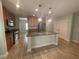 Modern kitchen with granite countertops, stainless steel appliances, and tile flooring at 878 Benjamin Trl, Davenport, FL 33837