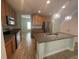 Well-appointed kitchen with stainless steel appliances, granite countertops, and wood cabinetry at 878 Benjamin Trl, Davenport, FL 33837