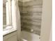 Elegant bathroom with a granite countertop, modern fixtures, and a tiled shower/tub combination at 9079 Dogleg Dr, Davenport, FL 33896