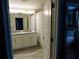 Elegant bathroom featuring dual sinks, granite countertops, and a shower/tub combo with curtain at 9079 Dogleg Dr, Davenport, FL 33896