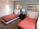 Inviting bedroom features two twin beds, stylish lamps, and tasteful decor for a cozy ambiance at 9079 Dogleg Dr, Davenport, FL 33896