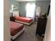 Comfortable bedroom boasts two twin beds, a dresser, and a large mirror for a relaxing stay at 9079 Dogleg Dr, Davenport, FL 33896