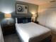 Serene bedroom features a queen bed with plush pillows and elegant nightstands for restful nights at 9079 Dogleg Dr, Davenport, FL 33896