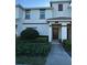 Inviting townhome with a well-maintained lawn and neatly trimmed shrubs at 9079 Dogleg Dr, Davenport, FL 33896