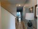 Hallway leads to dining room with chandelier; features tiled floors and tasteful decor at 9079 Dogleg Dr, Davenport, FL 33896