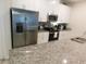 Modern kitchen featuring stainless steel appliances and granite countertops at 9079 Dogleg Dr, Davenport, FL 33896