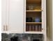 Open kitchen cabinet showcasing bowls and glassware at 9079 Dogleg Dr, Davenport, FL 33896