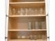 Organized kitchen cabinet displaying glassware at 9079 Dogleg Dr, Davenport, FL 33896