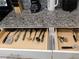 Convenient kitchen drawers with organized utensils and cooking tools at 9079 Dogleg Dr, Davenport, FL 33896