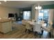 Light-filled dining and living area with stylish light fixture and sliding glass doors to the outdoor area at 9079 Dogleg Dr, Davenport, FL 33896