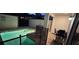 Nighttime ambiance in the backyard pool area, complete with grilling station and fence at 9079 Dogleg Dr, Davenport, FL 33896