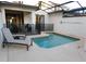 The private pool area includes comfortable lounge chairs, a built-in spa, and outdoor dining space at 9079 Dogleg Dr, Davenport, FL 33896