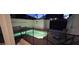 Dusk falls over the private pool and spa area with lounging chairs and a secure safety fence at 9079 Dogleg Dr, Davenport, FL 33896