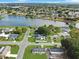 Aerial view of residential neighborhood with lake and community pool at 98 Pinata Ct, Kissimmee, FL 34743
