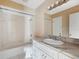 Bathroom featuring a vanity with marble counters, a large mirror and shower and tub combo at 98 Pinata Ct, Kissimmee, FL 34743