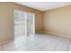 An additional bedroom that offers tile flooring, neutral paint and a sliding glass door with backyard access at 98 Pinata Ct, Kissimmee, FL 34743