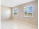 The bedroom features tile flooring, neutral paint and two windows that provide lots of natural light at 98 Pinata Ct, Kissimmee, FL 34743