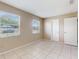 This bedroom has tile floors, neutral walls and two windows that provide plenty of natural light at 98 Pinata Ct, Kissimmee, FL 34743