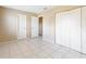 The bedroom includes tile flooring, neutral walls, two doors, and a large closet at 98 Pinata Ct, Kissimmee, FL 34743