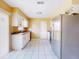 Bright kitchen featuring white cabinets, stainless steel appliances, tile flooring, and plenty of natural light at 98 Pinata Ct, Kissimmee, FL 34743