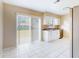 Bright kitchen features white cabinets, granite countertops, and tile flooring at 98 Pinata Ct, Kissimmee, FL 34743