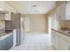 This kitchen features white cabinets, stainless steel appliances, tile flooring and lots of natural light at 98 Pinata Ct, Kissimmee, FL 34743