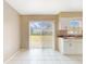 Bright kitchen featuring white cabinets, granite countertops, and sliding glass door at 98 Pinata Ct, Kissimmee, FL 34743