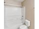 Bathroom featuring combination tub and shower with all-white tile at 1002 Chalcedony St, Kissimmee, FL 34744