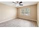 Bright bedroom features modern ceiling fan, wood-look floors, and a window view at 1002 Chalcedony St, Kissimmee, FL 34744