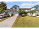 Two-story townhome community featuring well-manicured lawns, an attached one-car garage, and mature palm trees at 1002 Chalcedony St, Kissimmee, FL 34744