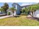 Landscaped lawn featuring a two-story townhome with an attached one-car garage and colorful shrubbery at 1002 Chalcedony St, Kissimmee, FL 34744
