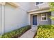 Townhome entrance featuring neatly trimmed hedges and a well-maintained walkway at 1002 Chalcedony St, Kissimmee, FL 34744