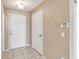 Hallway featuring ceramic tile floors and front door with sidelight at 1002 Chalcedony St, Kissimmee, FL 34744