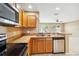 Spacious kitchen featuring stainless steel appliances, wood cabinetry, and a breakfast bar at 1002 Chalcedony St, Kissimmee, FL 34744