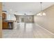 Open living area with ceramic tile floors and sliding doors to outdoor space at 1002 Chalcedony St, Kissimmee, FL 34744